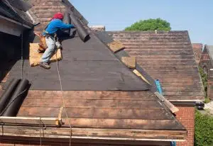 builder checking the condition and age of the roof
