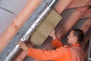 man installing attic ventilation