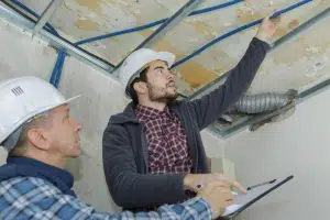 men investigating leaks on commercial roof