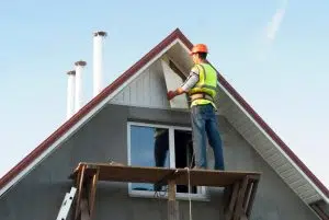 Roofing contractor working on soffit repair