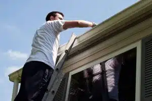 man doing a gutter inspection