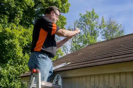 man doing roof inspection