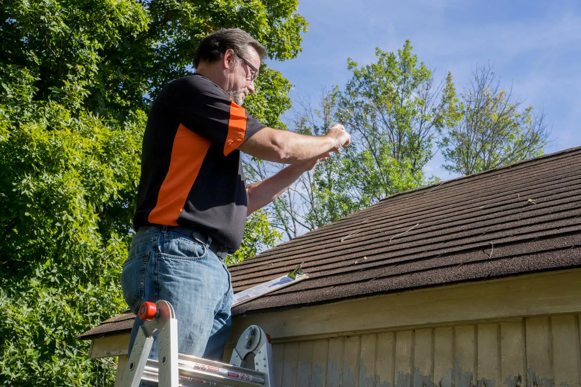 man doing roof inspection