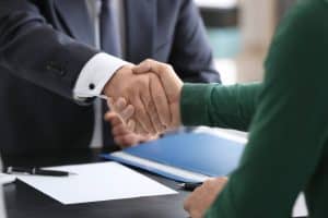 client shaking hands with a public adjuster