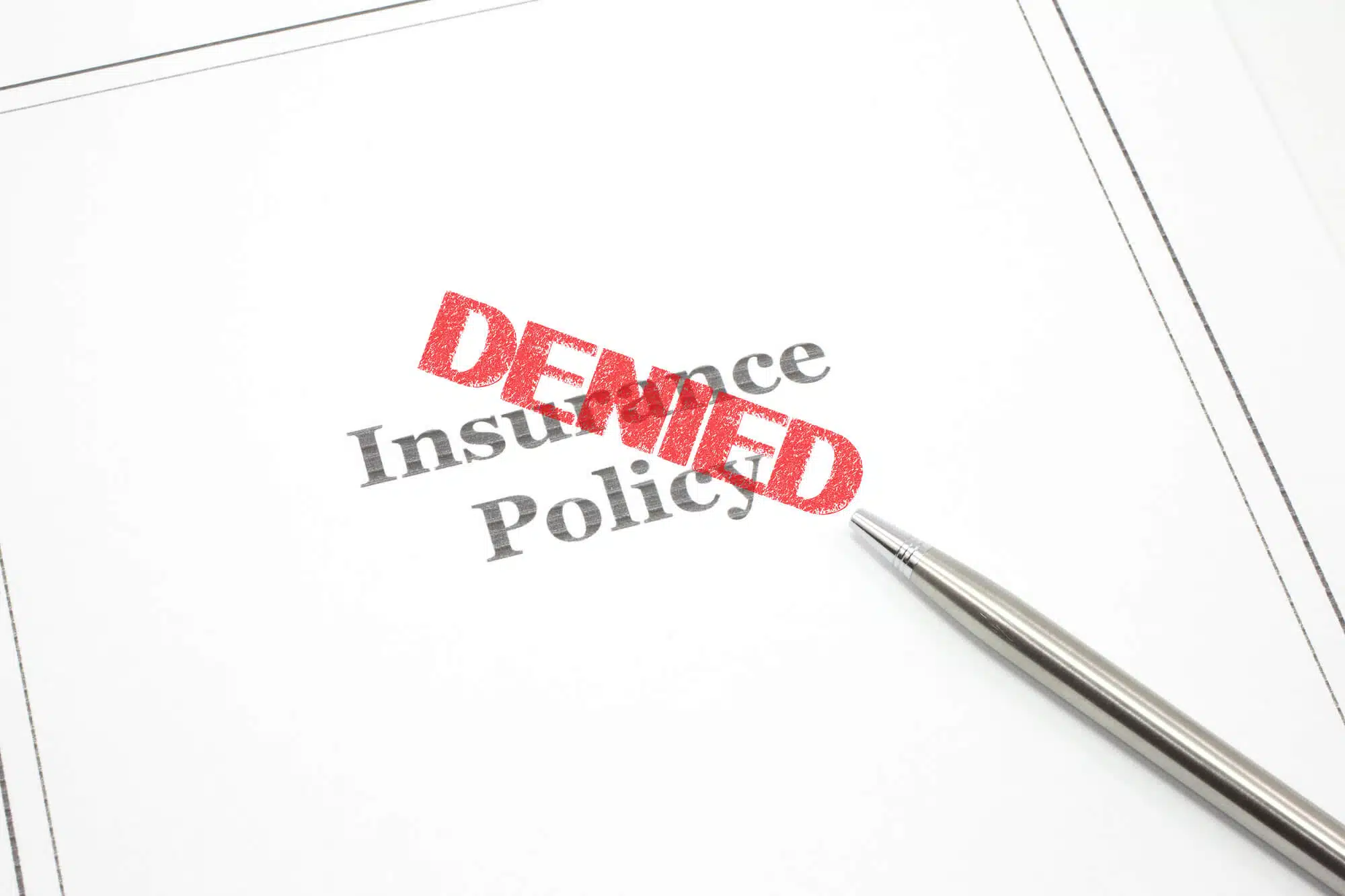 insurance policy denied written on a folder