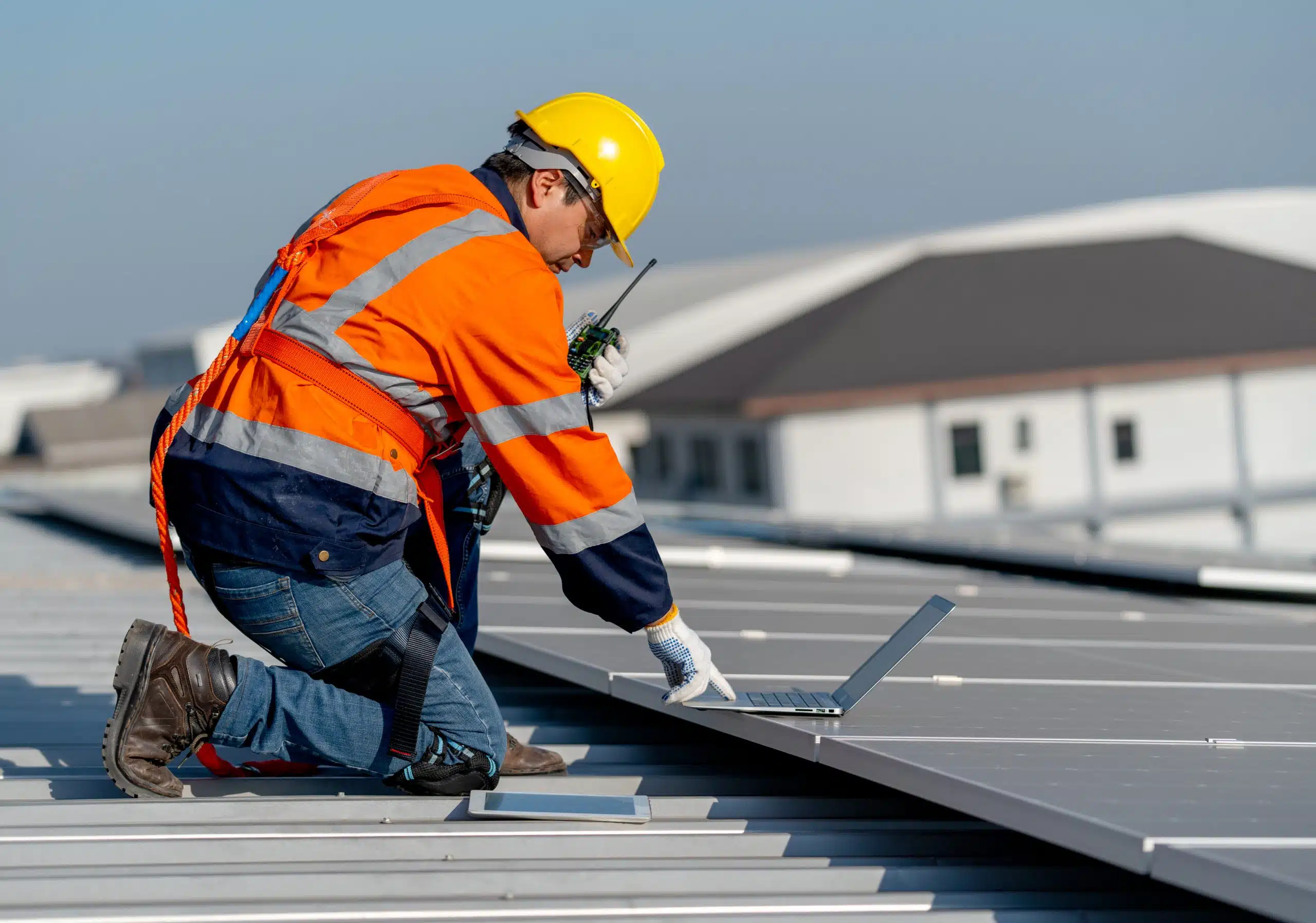 Commercial roof inspector examining TPO membrane seams on a flat-roofed New Orleans office building